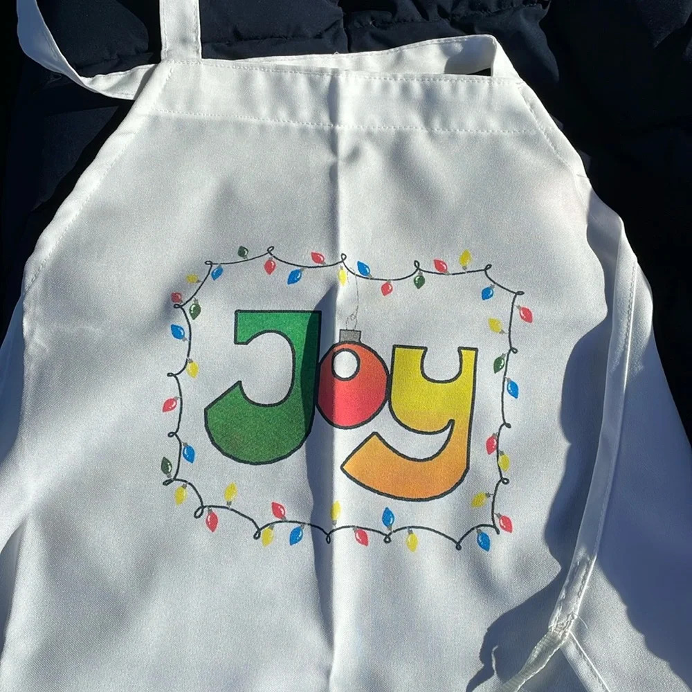 Apron, Xmas themed with “Joy”, Xmas lights/bulb. Full sized apron, ties in back